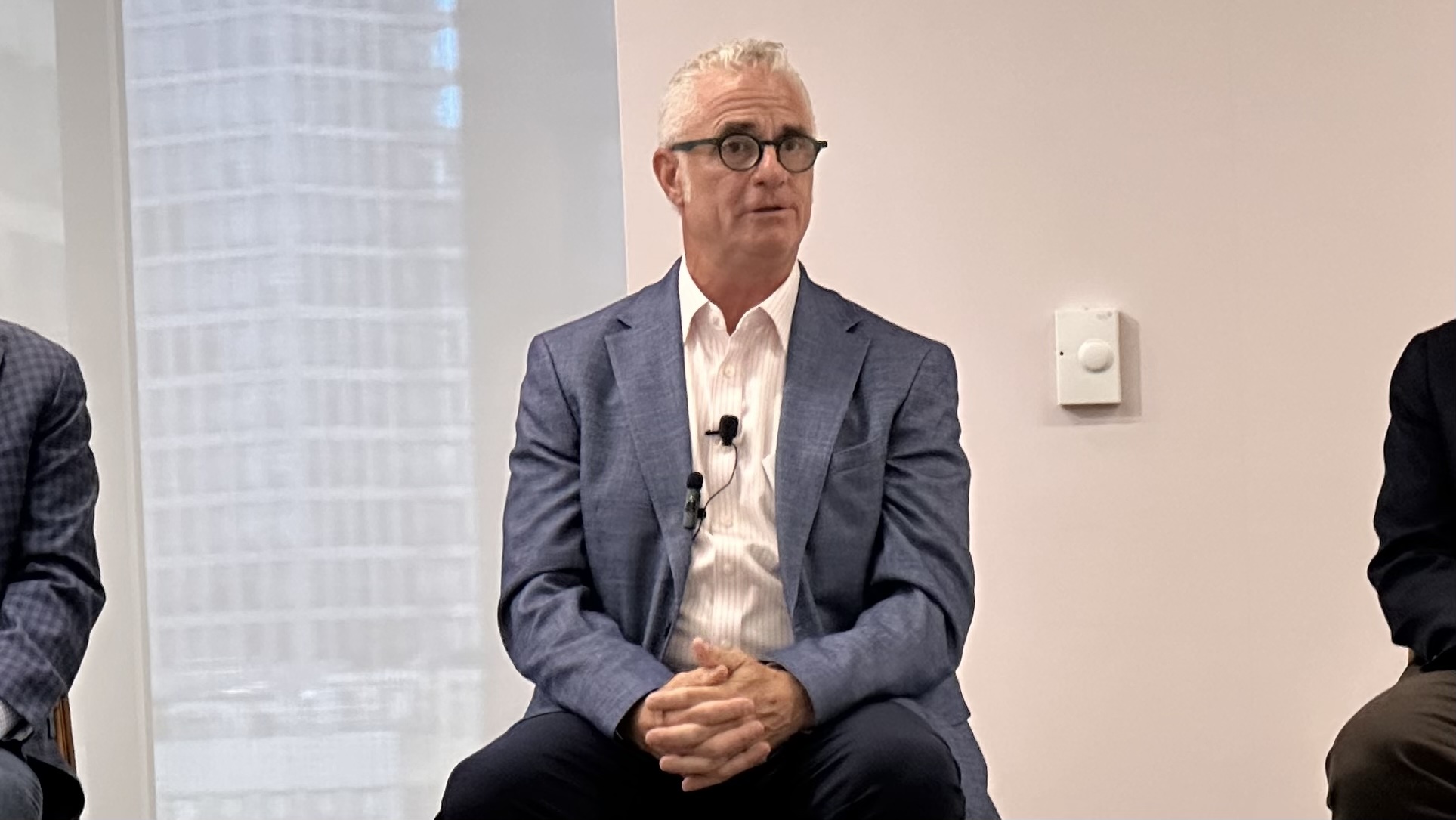 Jonathan Sheppard of J. Sheppard Associates seated on a panel with a microphone