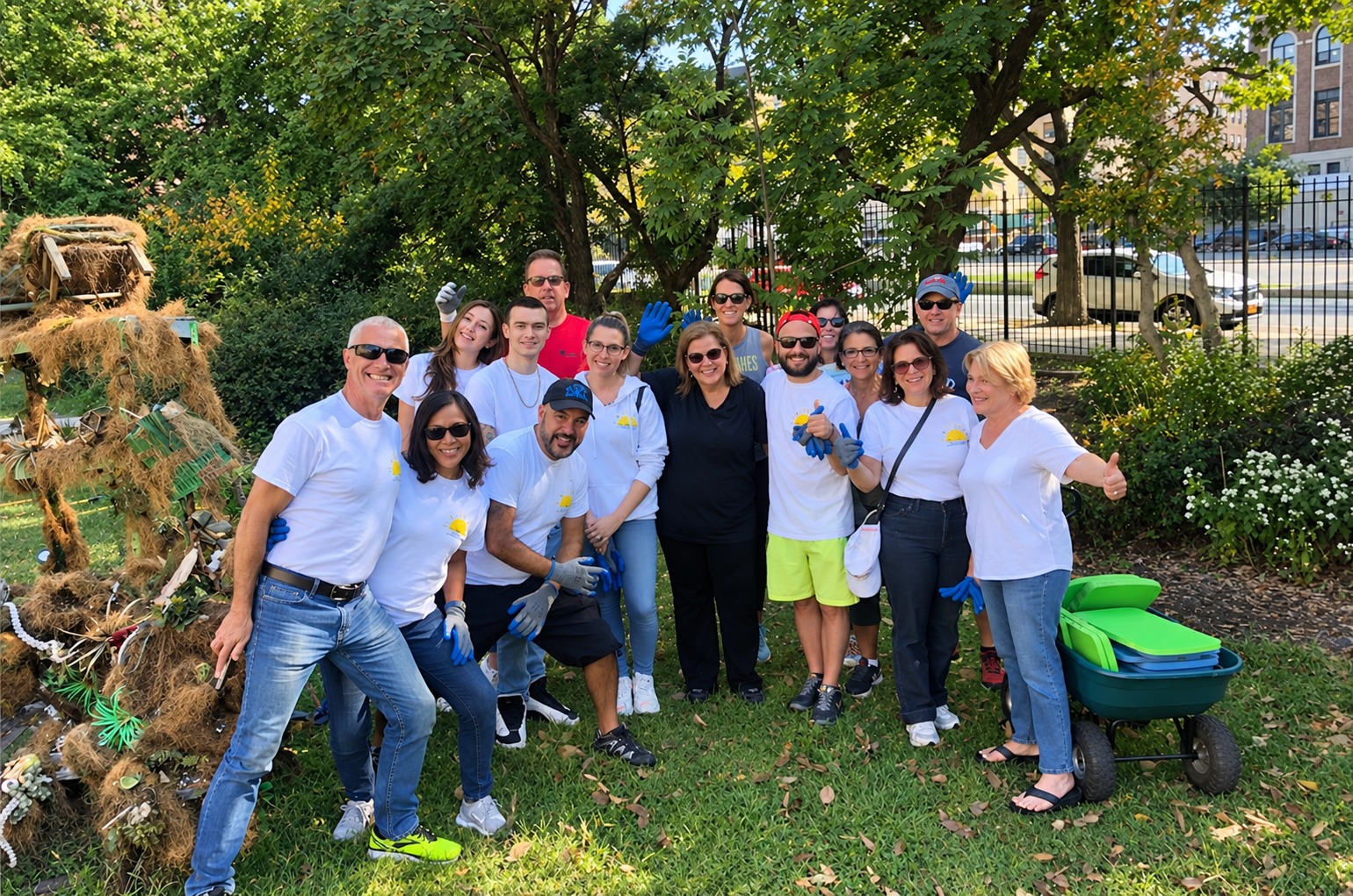 Group of volunteers in white JSA t-shirts at a community garden clean up