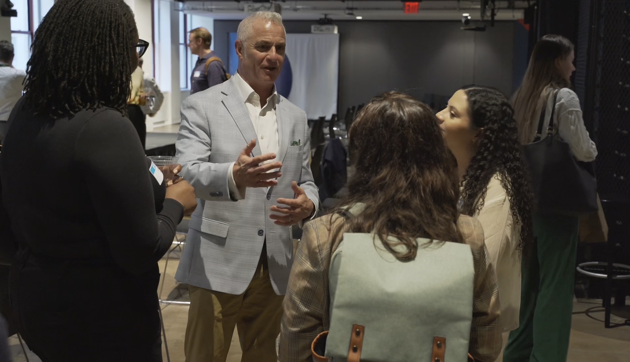 Jonathan Sheppard talking with attorneys and professionals at a networking event